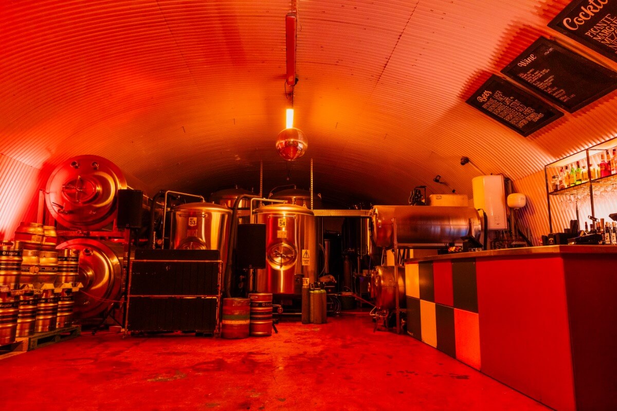 The brewery event space in red atmospheric lighting