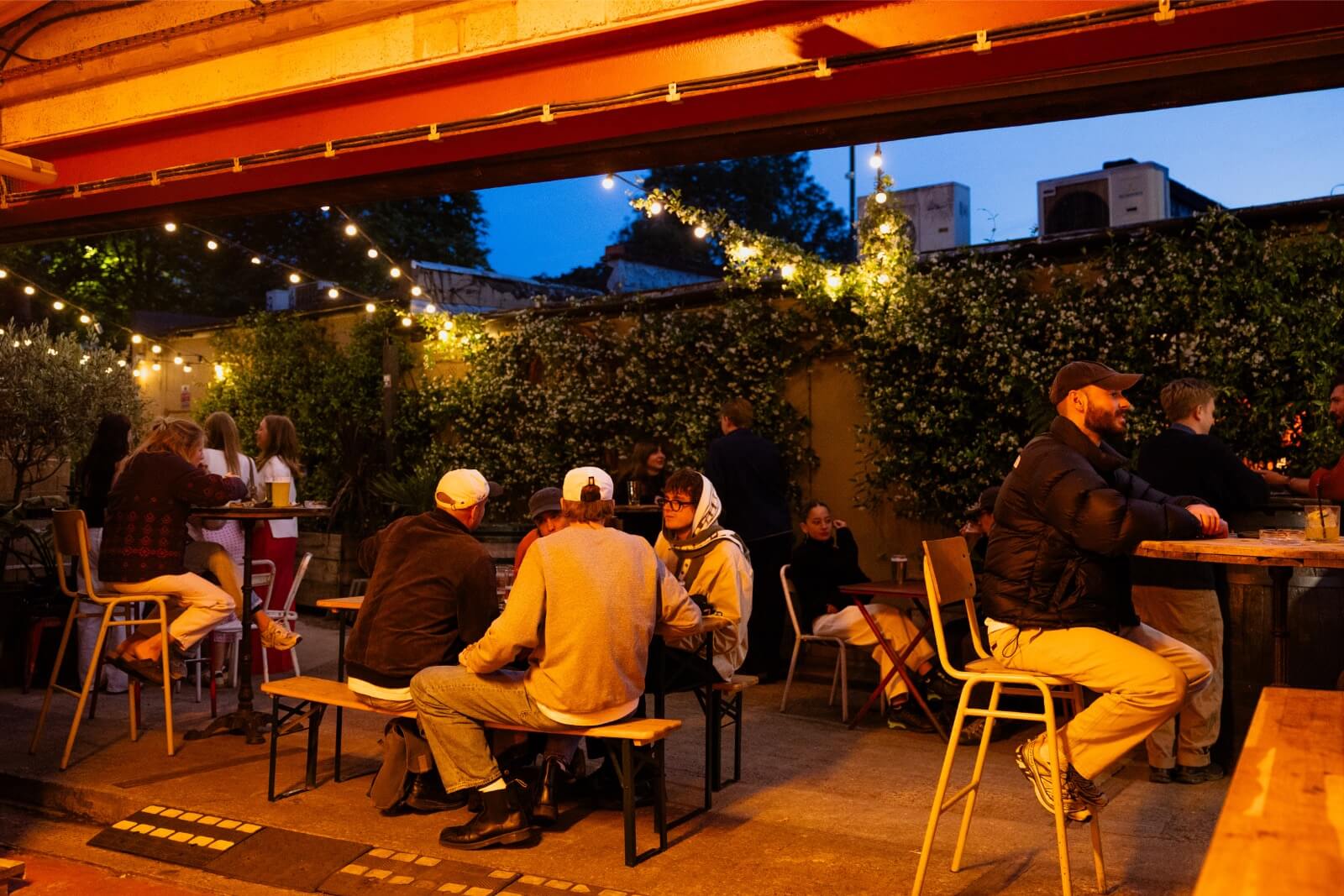 People sitting enjoying drinks outside with coats on