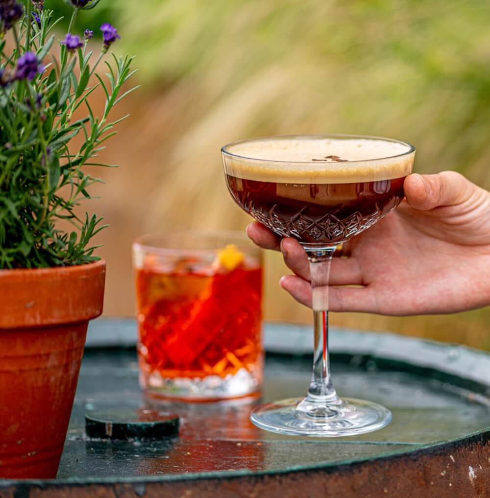 Expresso martini and negroni on a barrel in the garden