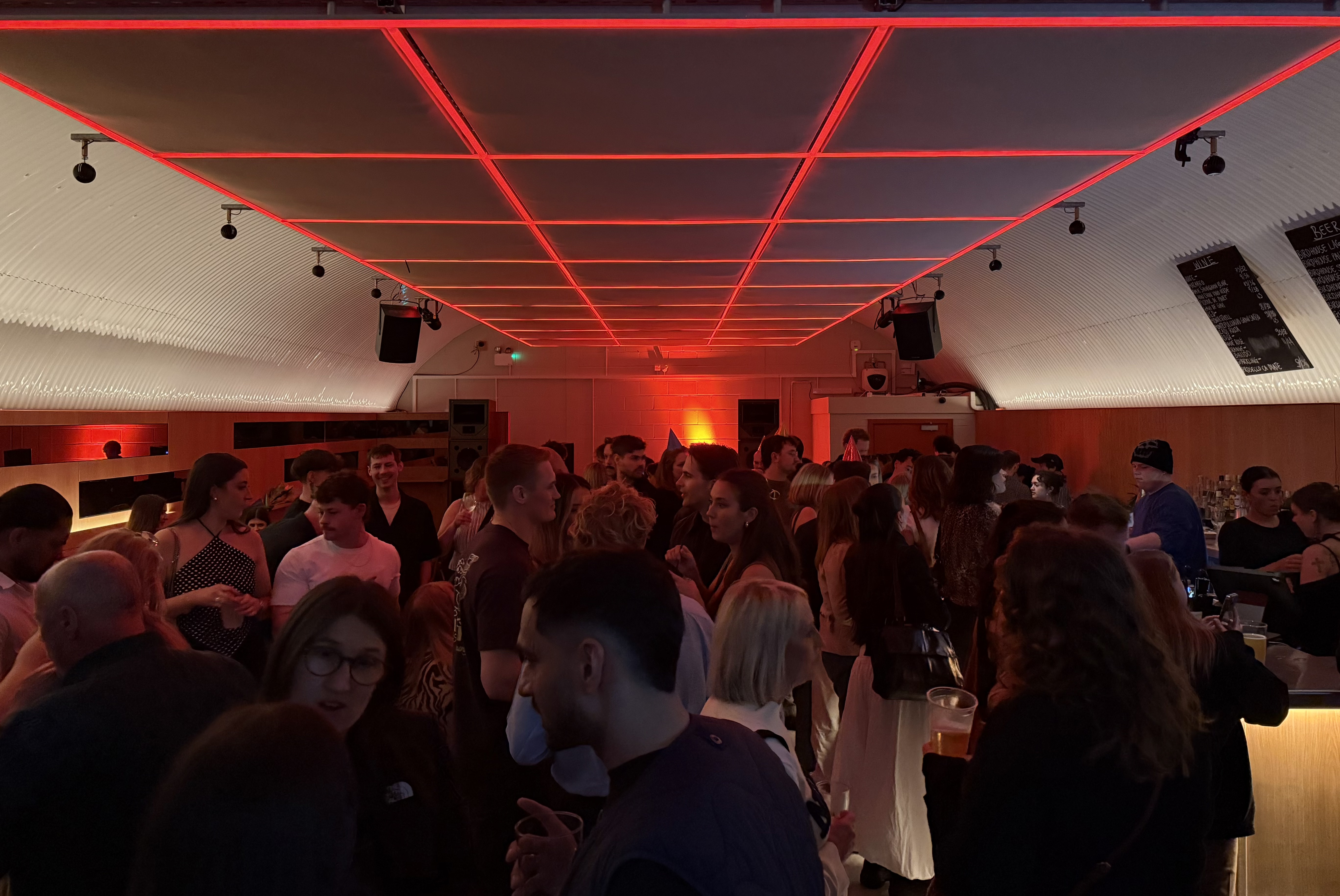 Guests chatting and dancing in a cool pub room