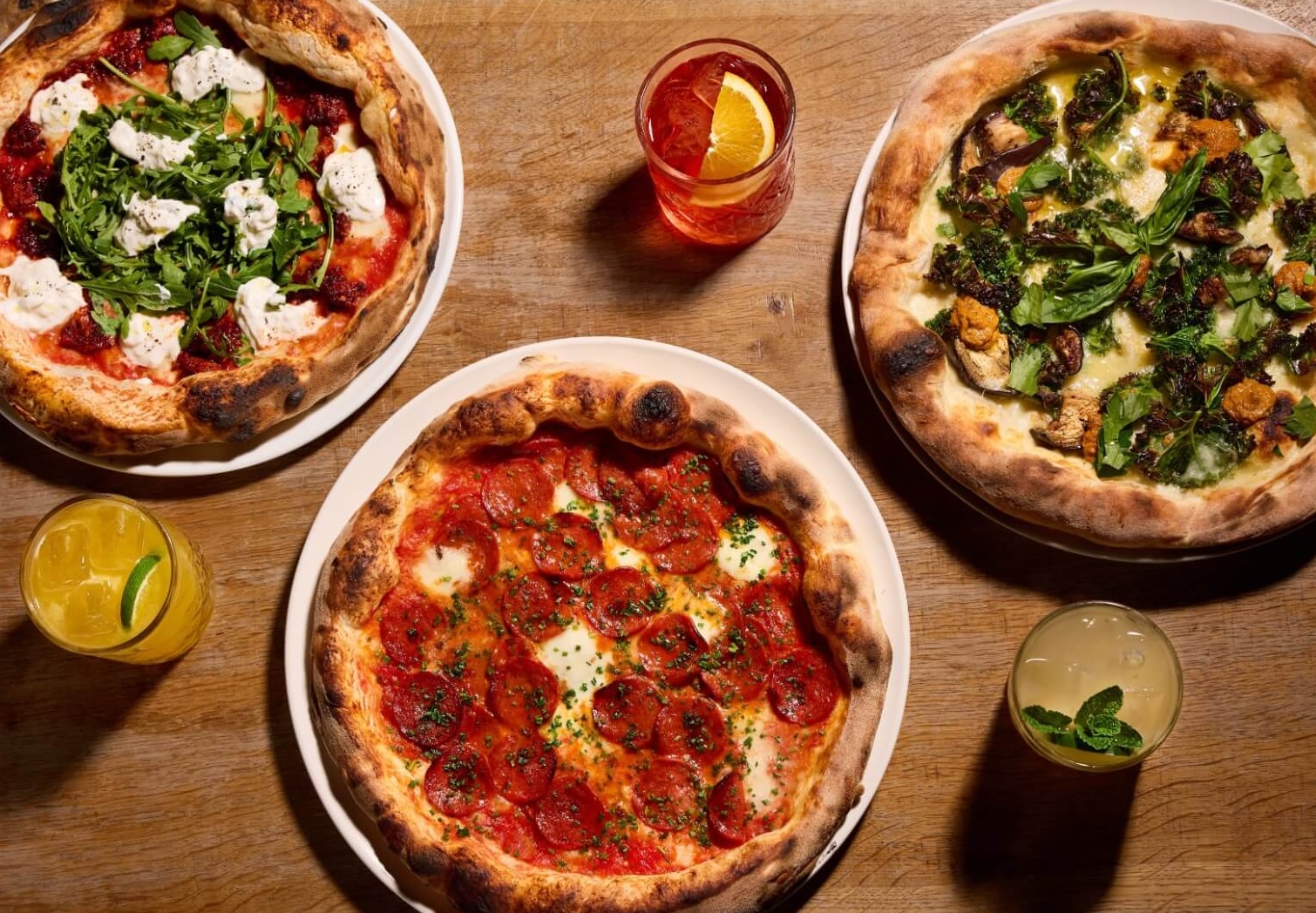 Wood-fired pepperoni, nduja rocket, kale and aubergine pizzas fresh from the oven