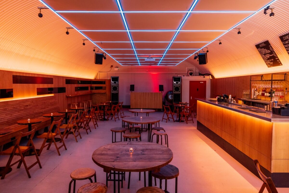 Salsa dancers dancing in a well lit red room